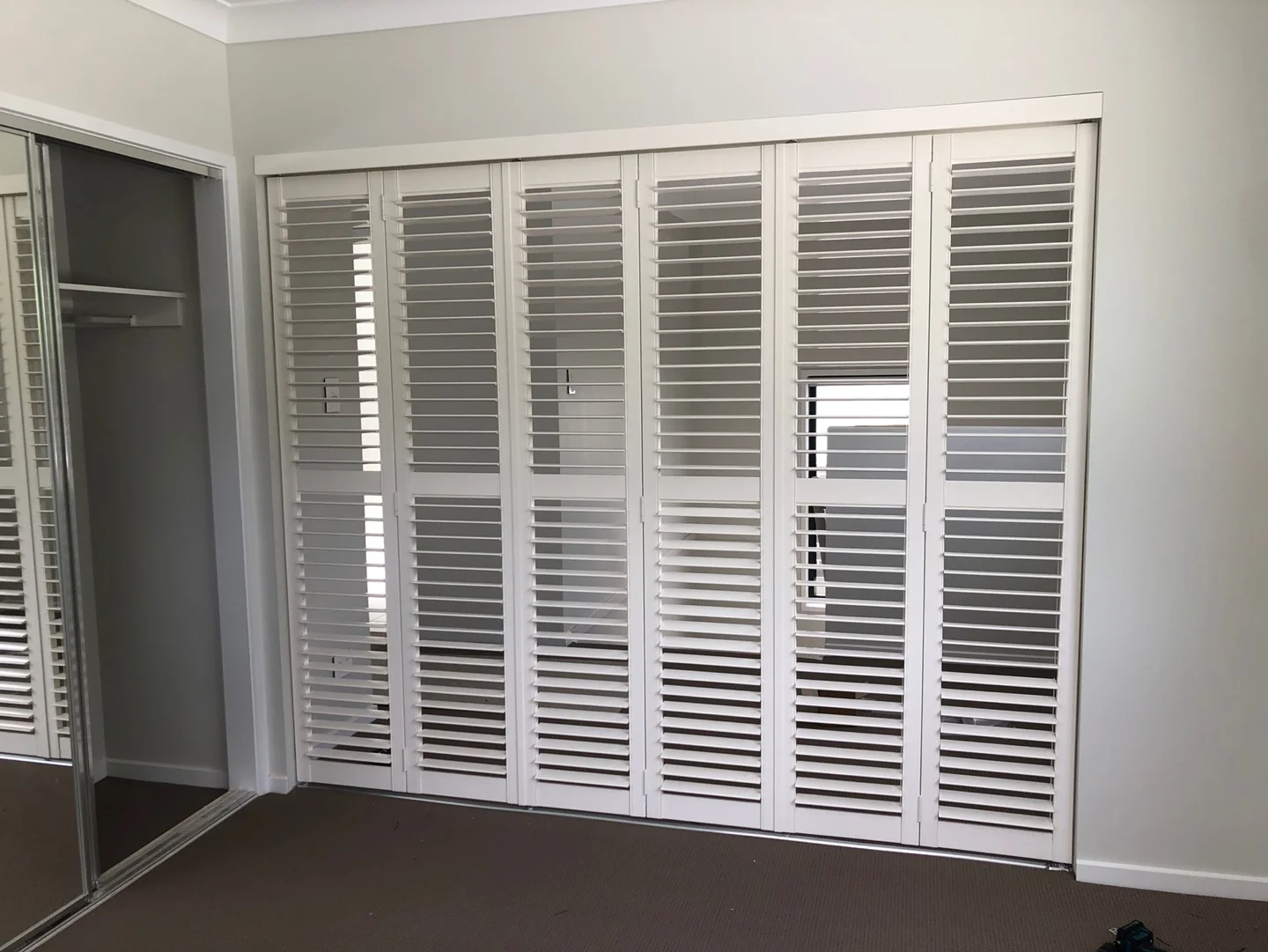 six-panel-track-bifolding-shutters-room-divider-brisbane-1 — Shutter Track Bifolding Bi-folding shutters as room divider — multi purpose room — shutters